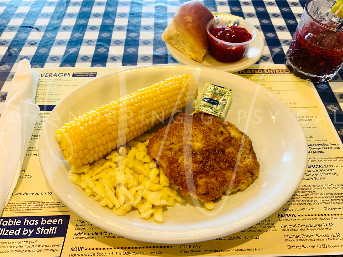 This photo showcases a mouthwatering plate of Wiener Schnitzel, Sturla, and corn on the cob, served up at the historic Ox Yoke Inn restaurant in Amana, Iowa. These classic German dishes are a staple of Amana's rich culinary heritage, and the Ox Yoke Inn is renowned for its authentic preparation and warm, welcoming atmosphere. From the crisp, breaded exterior of the Schnitzel to the tender strudel and the perfectly cooked corn on the cob, this plate offers a true taste of Amana's vibrant history and traditions.